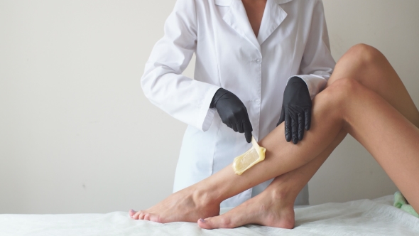 Woman in a Beauty Salon Doing Depilation alt