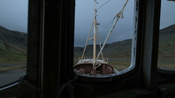 Shipwreck on a Beach with a Dramatic Sky in Patrekfjordur at the Westfjords alt