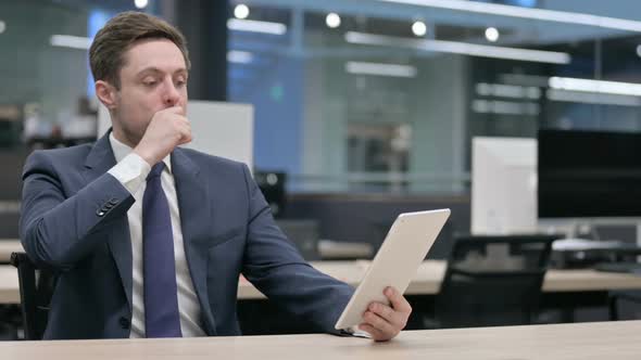 Businessman Reacting to Loss on Tablet in Office Sitting alt