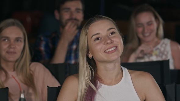 Happy Friends Watching Comedy Movie in Theater alt
