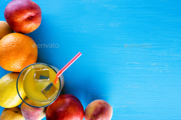 Fresh tropical fruits and a glass of juice with ice - Stock Photo - Images