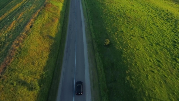 Aerial View of Sport Car Driving in Fields