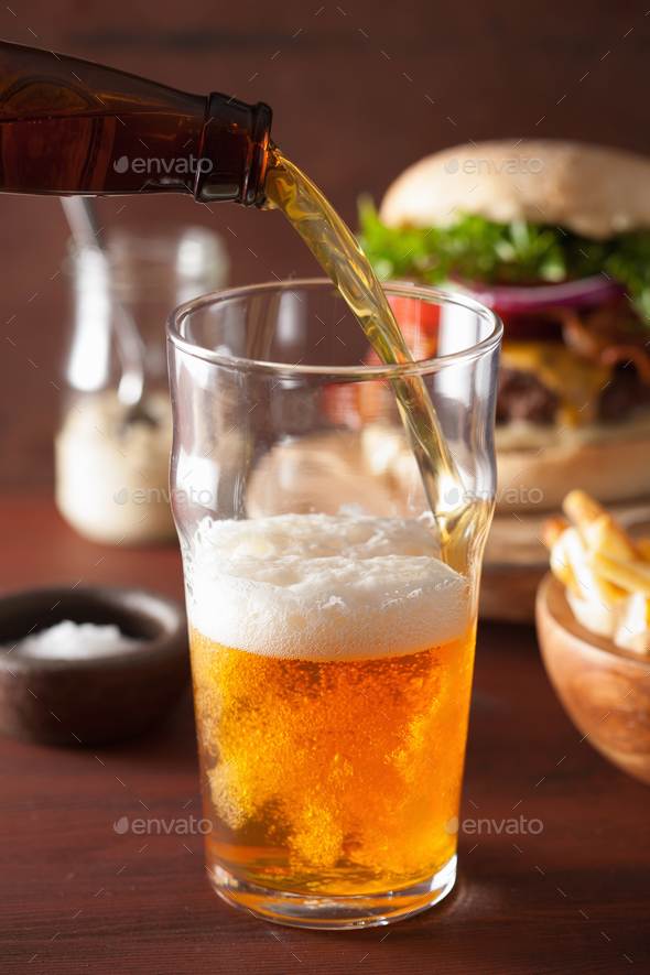 pouring india pale ale beer into pint glass and fastfood
