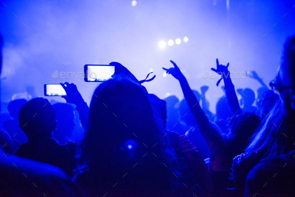 Crowd of people using smart phones to photographing a concert