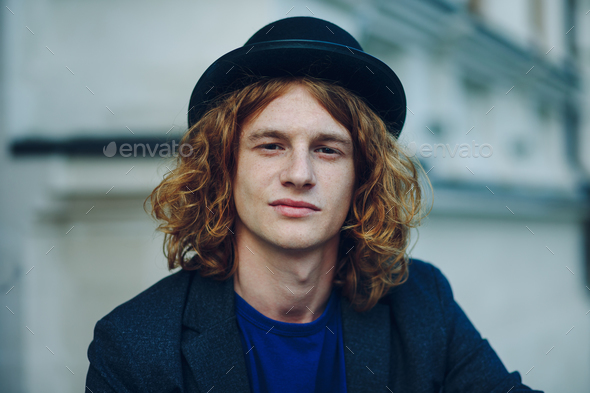 Close-up portrait of young reddish curly man - Stock Photo - Images