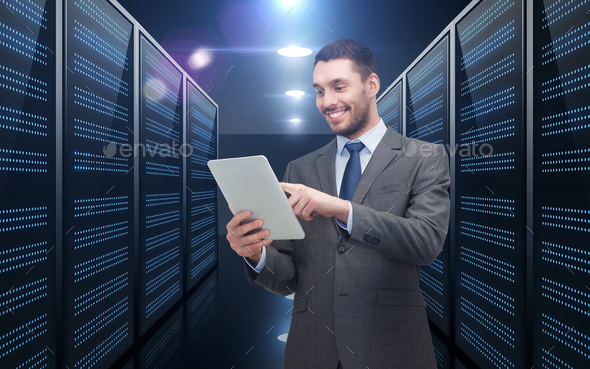 businessman with tablet pc over server room