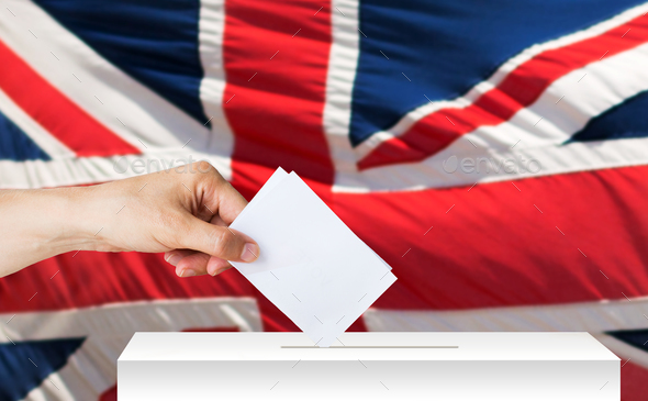 hand of englishman with ballot and box on election