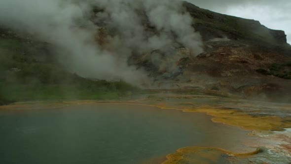 dramatic iceland landscape, geothermal hot spring pool steam smoke rising, beautiful relaxing nature