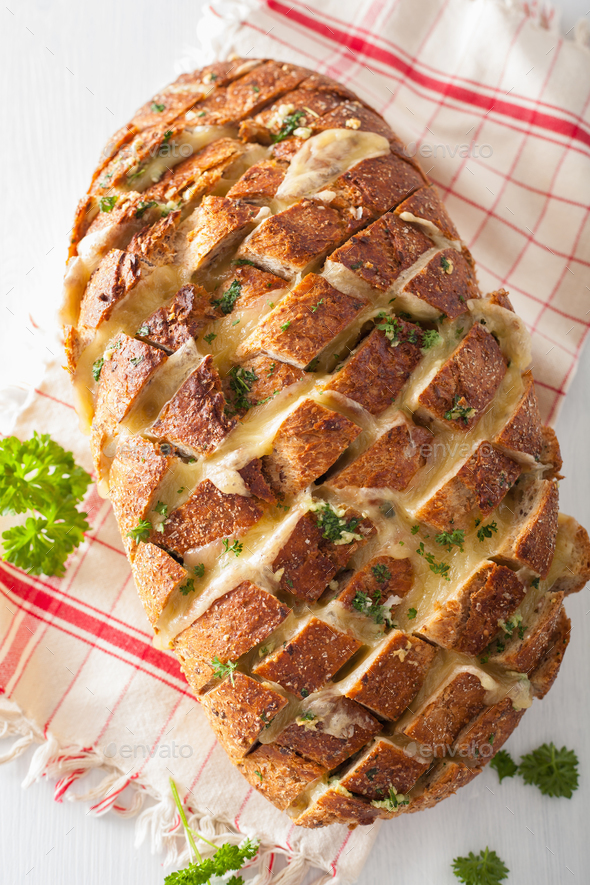 baked party bread with melted cheese butter herbs Stock Photo by duskbabe