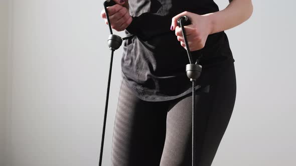 Woman in a Black Sportswear Doing Exercises Using Expander on the Stepper alt
