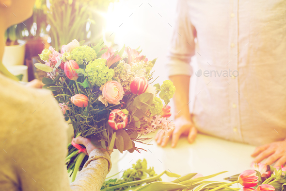 close up of florist woman and man at flower shop