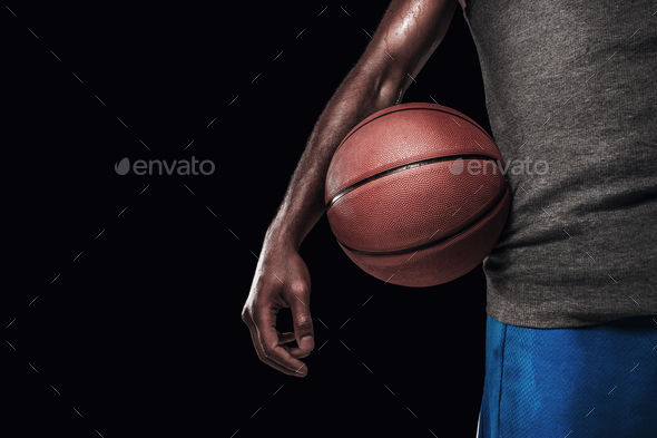 The hands of a basketball player with ball - Stock Photo - Images
