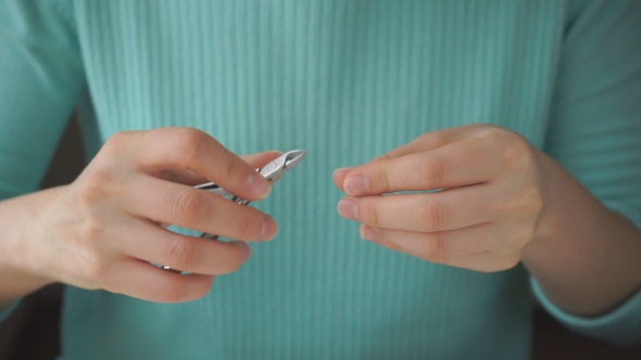 Woman Makes Herself Manicure with Tweezers