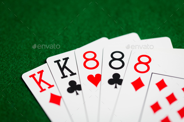 poker hand of playing cards on green casino cloth - Stock Photo - Images