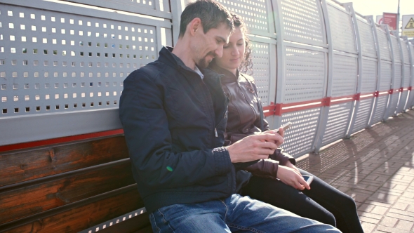 Man and Woman Are Waiting for Train on Platform