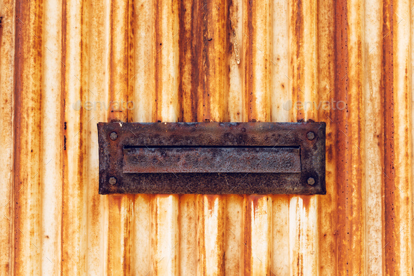 Weathered old rusty mail slot letterbox