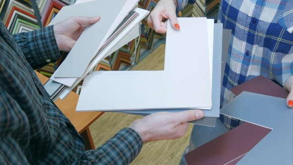 Hands Holding Passepartout for Package Picture in Frame alt