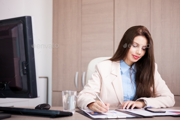 Young professional businesswoman working in the office