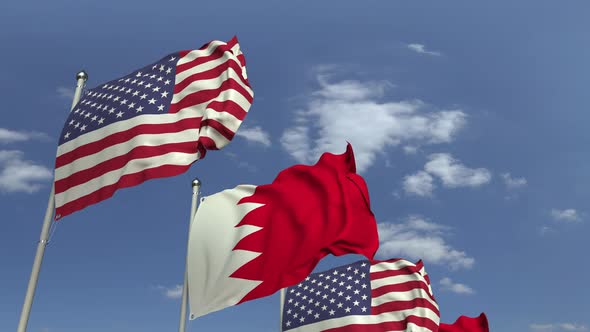 Waving Flags of Bahrain and the USA on Sky Background alt