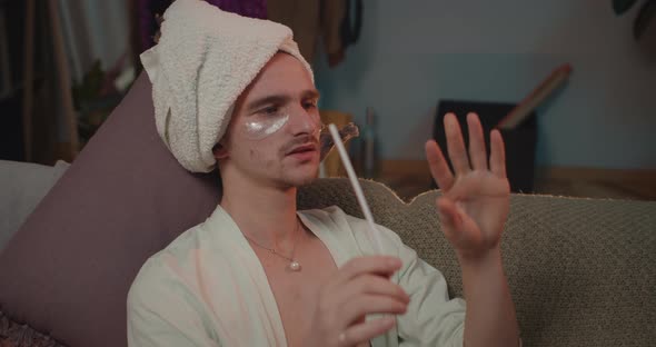 Close Up of Relaxed Transgender Making Manicure and Drinking Wine While Lying at Sofa. Young Trans alt