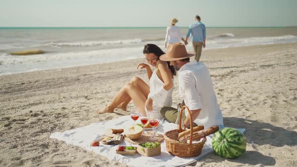 Beautiful Stylish Young Family Couple Happy Husband and Wife Sit on Cozy Picnic Blanket alt