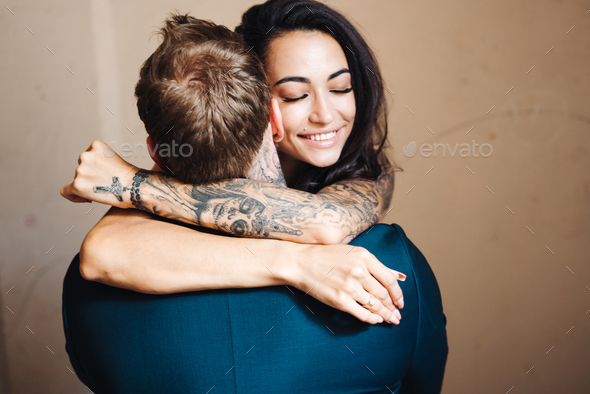 Beautiful, young couple posing on camera indoors - Stock Photo - Images
