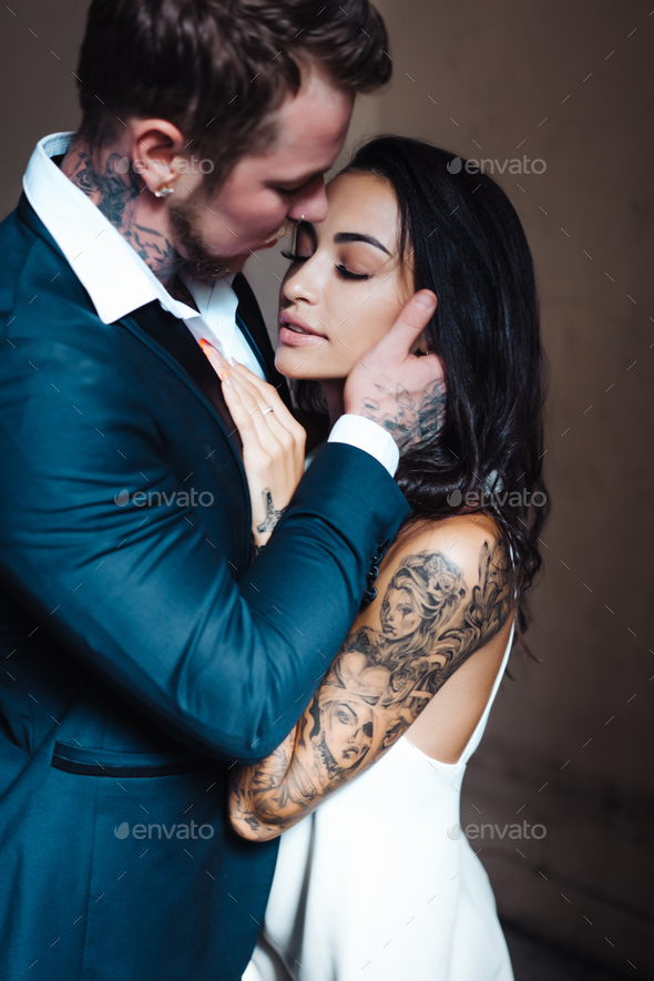 Beautiful, young couple posing on camera indoors - Stock Photo - Images