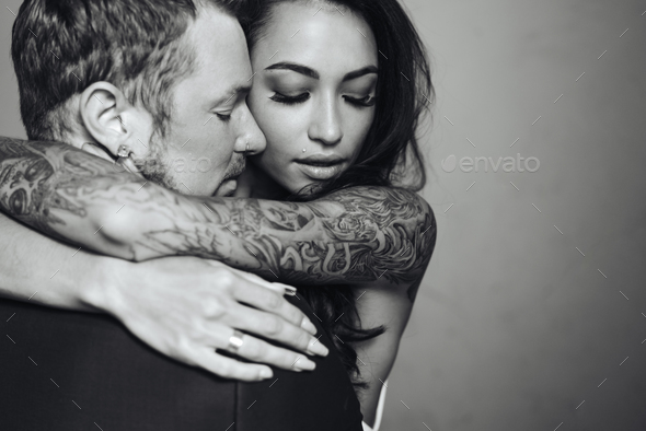 Beautiful, young couple posing on camera indoors - Stock Photo - Images