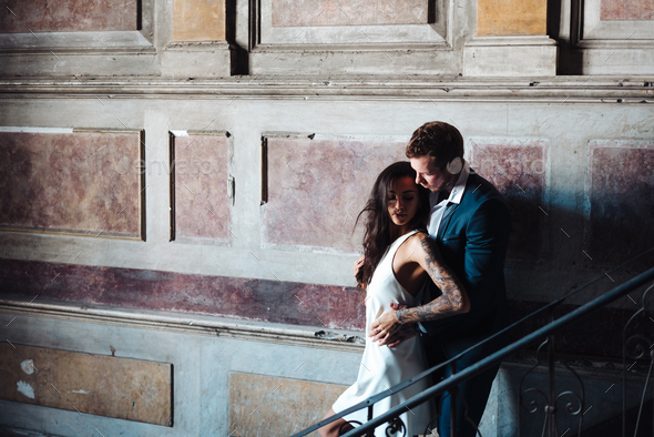Beautiful, young couple posing on camera indoors - Stock Photo - Images