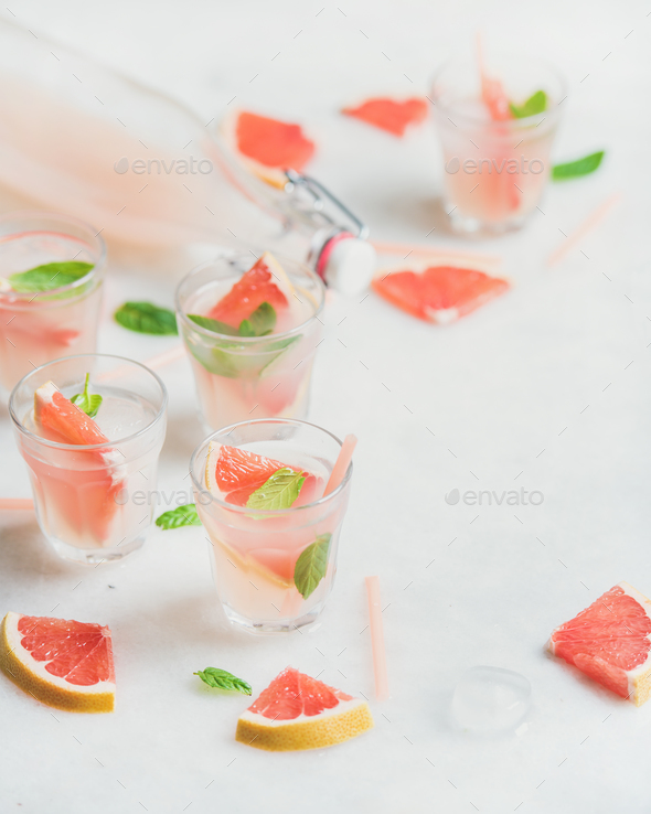 Cold refreshing alcohol cocktail with fresh grapefruit, white background - Stock Photo - Images