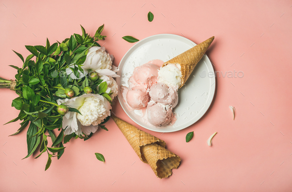Pink strawberry and coconut ice cream, cones, white peony flowers - Stock Photo - Images