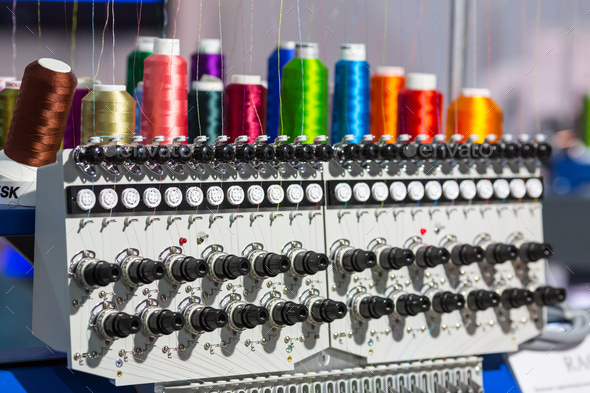 Spools of color threads closeup, spinning machine - Stock Photo - Images