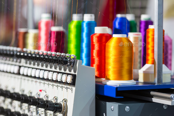 Spools of color threads closeup, spinning machine - Stock Photo - Images