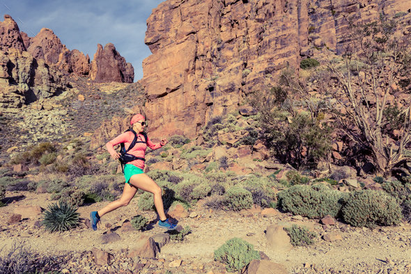 Woman trail running in mountains with backpack - Stock Photo - Images