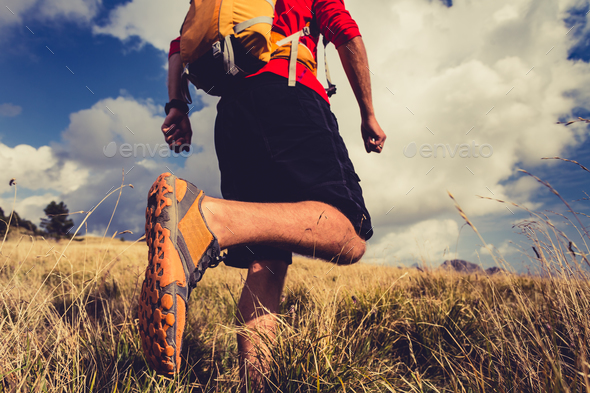 Hiker walking with backpack in beautiful landscape - Stock Photo - Images