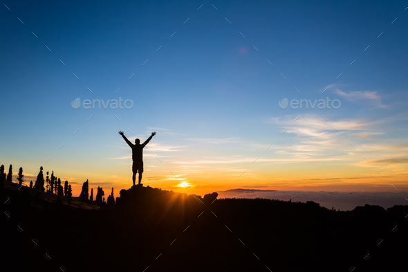Man hiker silhouette with arms outstretched enjoy mountains - Stock Photo - Images