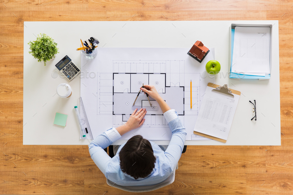 architect with compass measuring blueprint - Stock Photo - Images