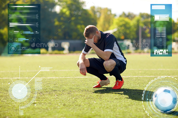 sad soccer player with ball on football field