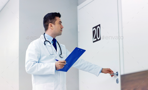 doctor with clipboard opening hospital ward door