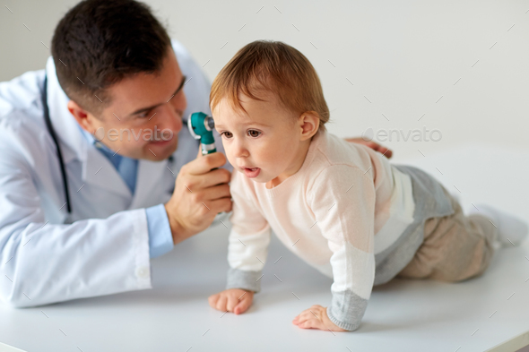 doctor with otoscope checking baby ear at clinic - Stock Photo - Images