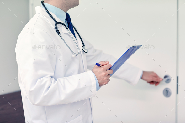close up of doctor with clipboard at hospital door