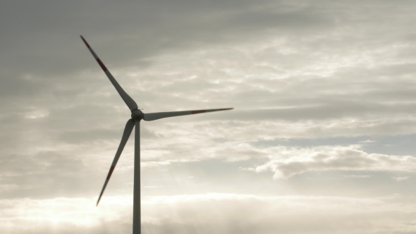Wind Turbine Over Stormy Cloudy Sky Using Renewable Energy To Generate Electrical Power