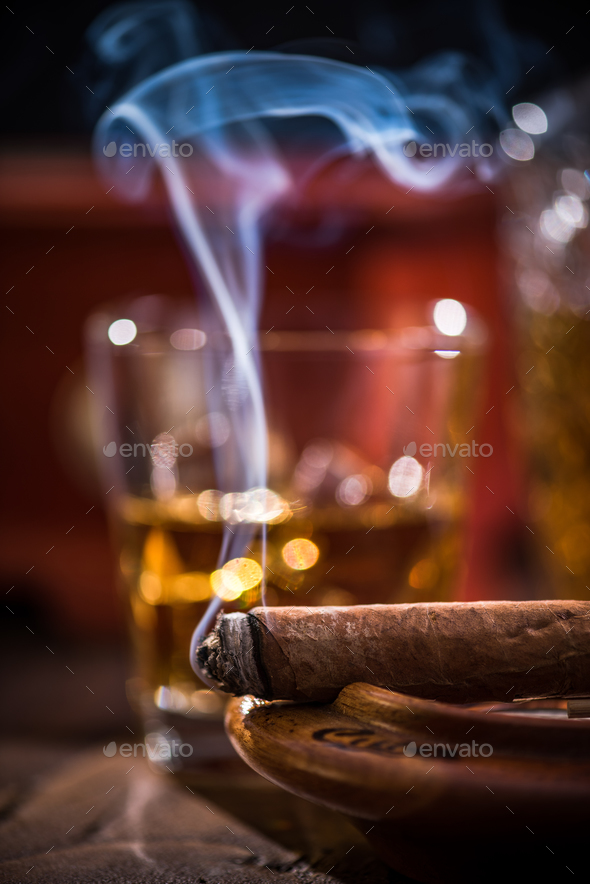 Cuban cigar smoke and luxurious Cognac in carafe