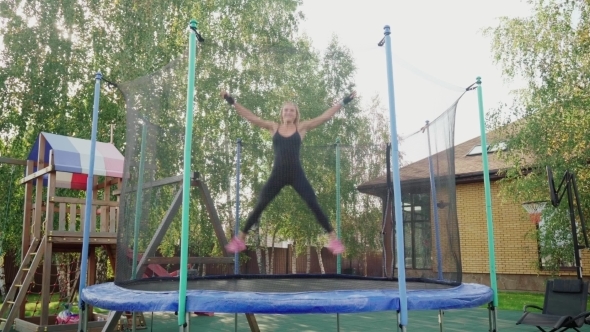 Woman Jumping on a Trampoline