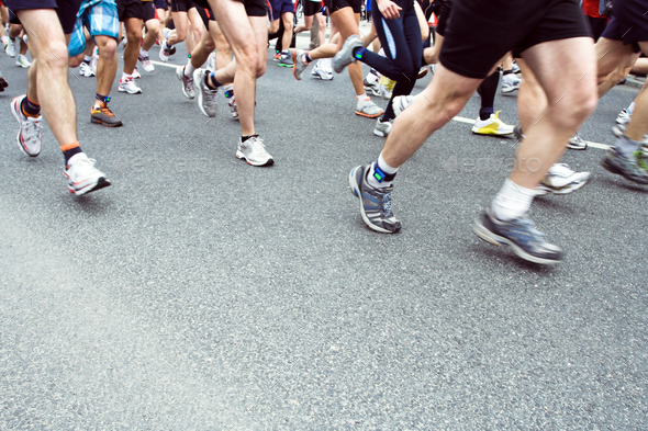 People running in city marathon on street, motion blur