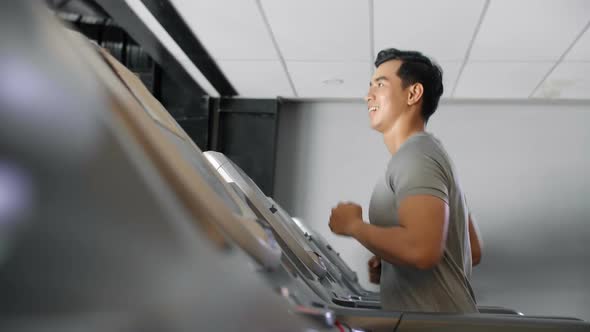 Asian Sportsman Running on Treadmill alt