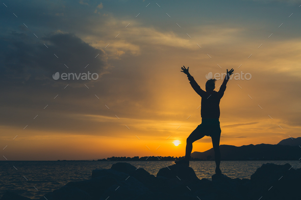 Girl hiker with arms outstretched enjoy beach and sea