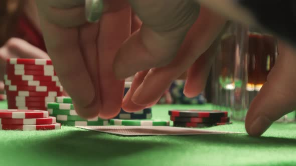 Looking Bad Poker Cards. On the Background Sexy Woman Player Checking Her Hand