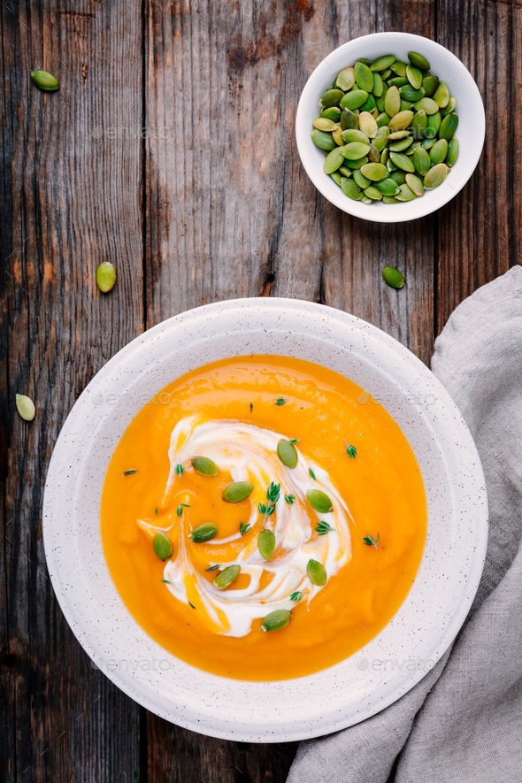 Homemade pumpkin soup with cream and seeds