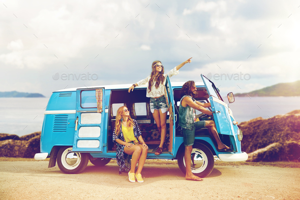 happy hippie friends in minivan car on island